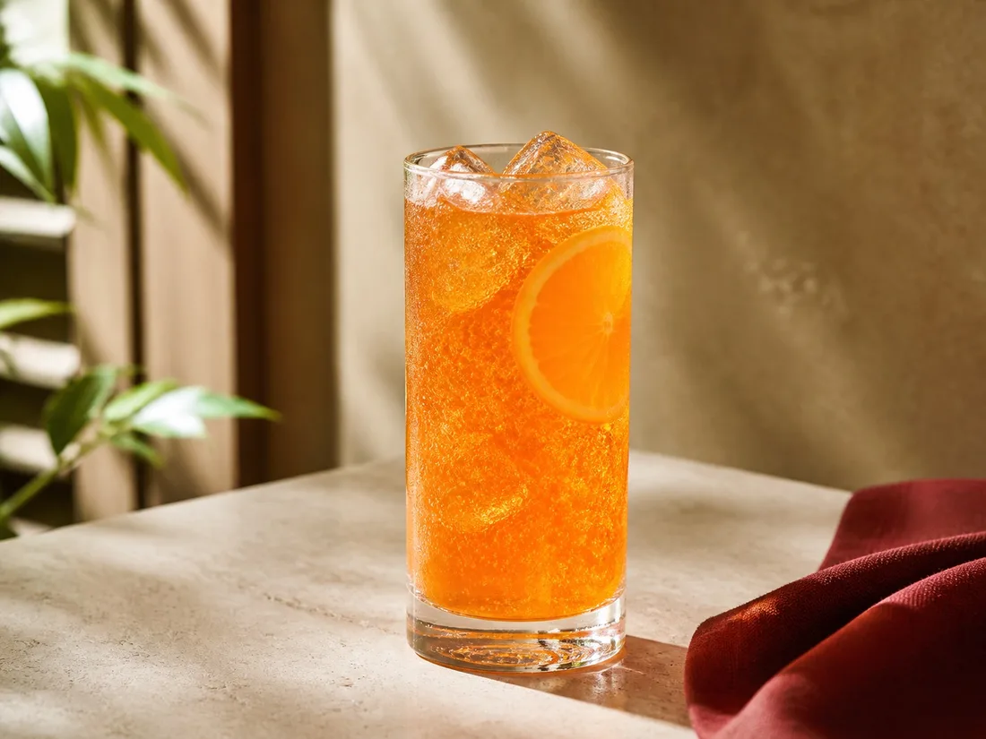 Sparkling orange soda over ice